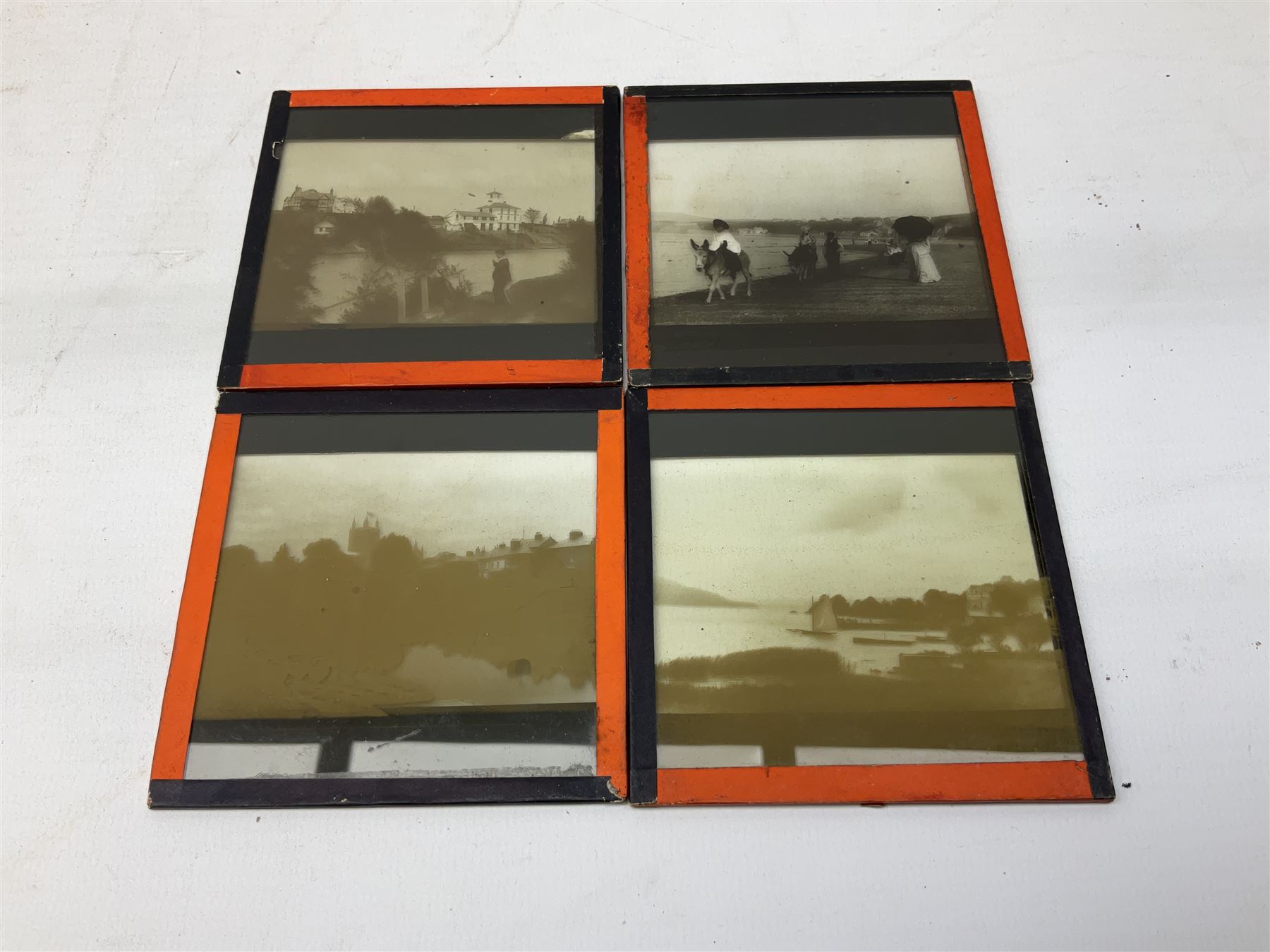 Large collection of over three hundred glass magic lantern slides including country, beach, town and street scenes, some with figures and animals