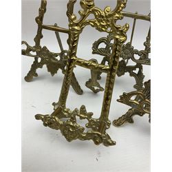Nine ornate cast brass easel stands of various sizes, H24cm