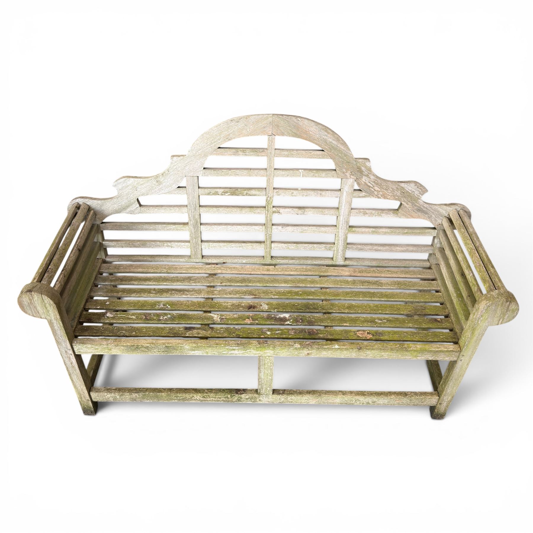 Lutyens design weathered teak garden bench with matching two-tier table, the bench with shaped arched and slatted back over rolled arms and slatted seat