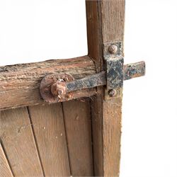 Pair of 19th century weathered wooden ecclesiastical church gates, the cresting rail over four pierced arches with slatted lower section, fitted with heavy cast iron hinges, latch and fittings