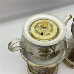 Two 19th century continental teapots and warmers, each teapot upon a cylindrical warming base, hand printed with landscapes and seascapes, largest H22cm