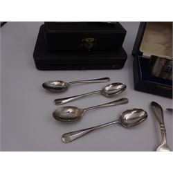 Group of silver, comprising two engraved napkin rings, Christening fork and spoon, engraved with name, similar pusher, four teaspoons and a miniature silver mounted photograph frame, all hallmarked