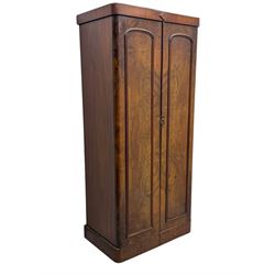 Victorian figured walnut single wardrobe, the moulded cornice with a central diamond motif over a pair of arched panelled doors with striking book-matched veneers, enclosing a fitted interior with hanging rail and hooks, on a plinth base