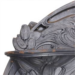 Art Nouveau cast iron fireplace, shaped hood with scrolling foliate crest, relief cast panel of female figure seated within shell form amidst wave motifs, uprights cast with foliate designs