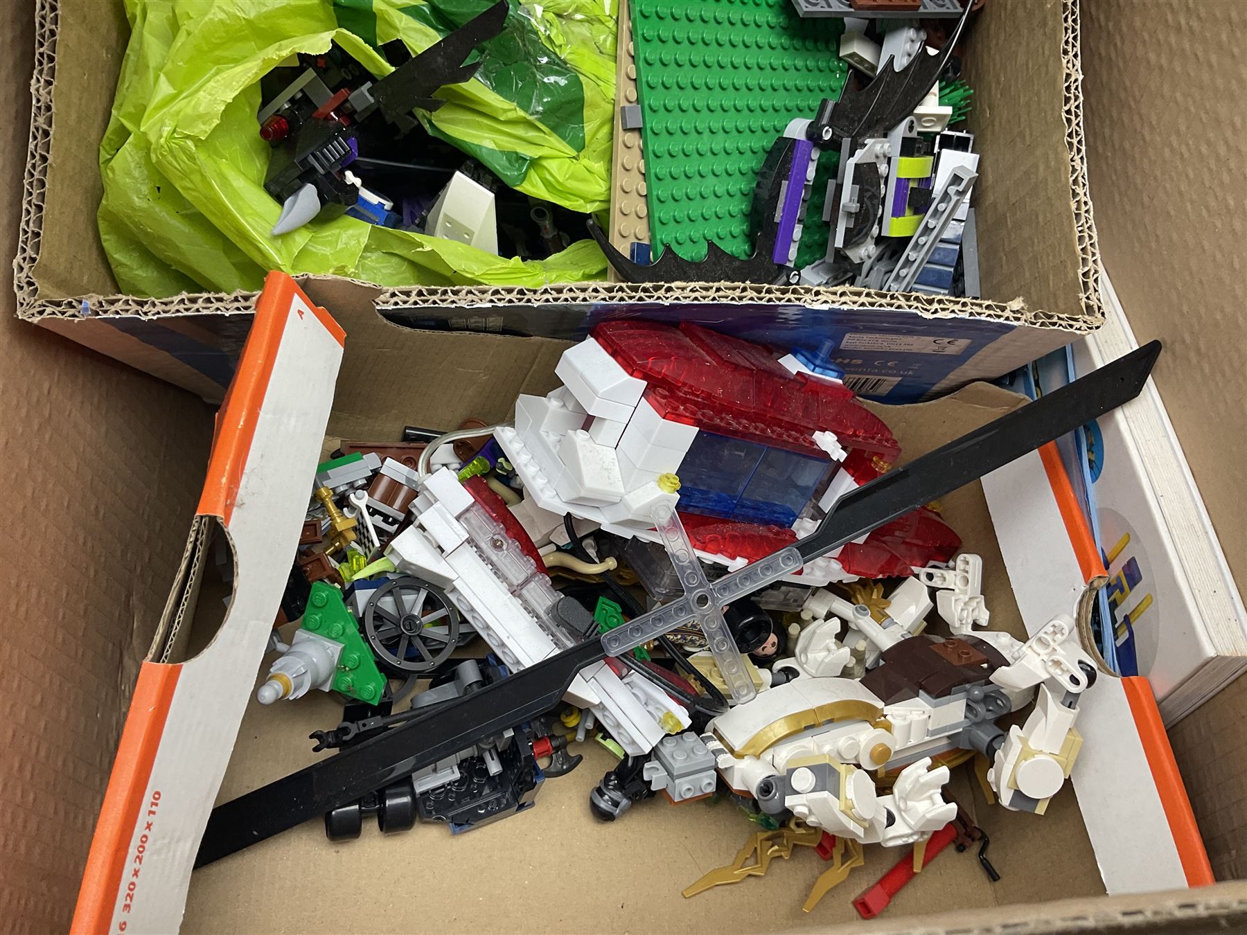Very large collection of Lego, predominantly loose but some part constructed models, including Lego City, Lego Technic, Chima, Arctic 5, train set, mobile crane etc; together with numerous instruction booklets and some empty boxes; contained in two large cardboard boxes with gross weight of over 24kgs