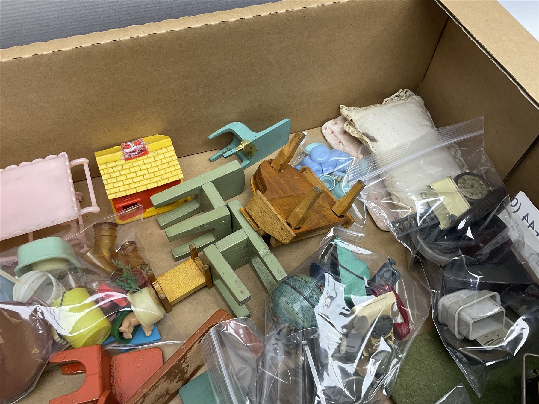 Quantity of various scale 1930s doll's house furniture including wooden grand piano, tables and chairs etc; plastic accessories including Fairy Lite sewing machine, trays, table wares, buckets, high chair etc; metal items including tin-plate doll's pram, terrestrial globe, die-cast typewriter and telephone, companion set and coal scuttle etc