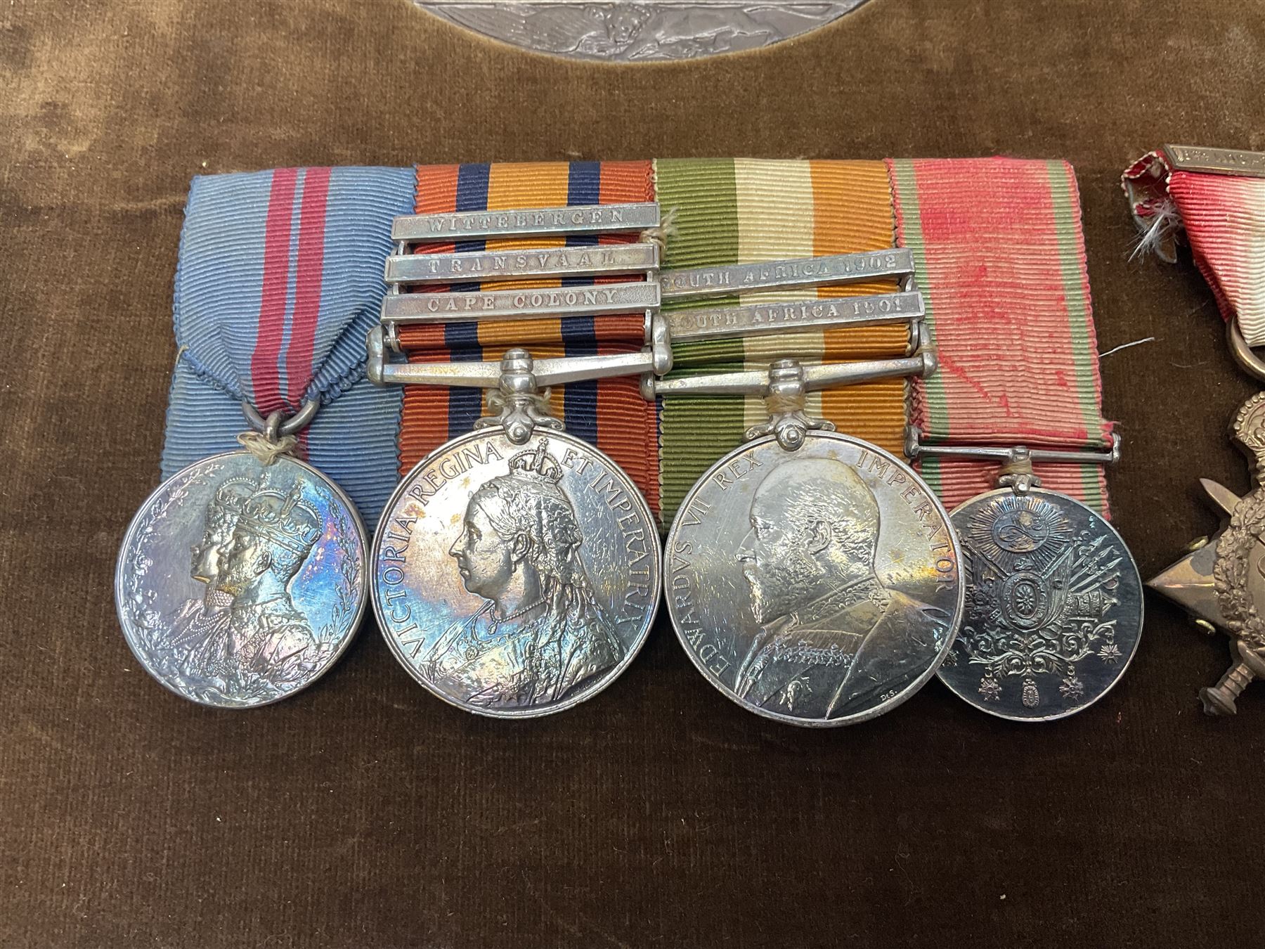 DOW Eure-et-Loir group of seven Boer War/WW1 medals comprising Queens South Africa Medal with three clasps for Cape Colony, Transvaal and Wittebergen, Kings South Africa Medal with two clasps for South Africa 1901 and South Africa 1902, Turkish Liakat Medal, George V Coronation Medal, 1914 Star with 5th Aug.-22nd Nov. 1914 bar, British War Medal and Victory Medal awarded to Captain Douglas Leslie Stephen Grenadier Guards; group of four Boer War and 1911 Coronation miniature medals; all with ribbons and later mounted and framed with his bronze memorial plaque;  together with Cecil Cutler (active 1886-1934) heightened watercolour three-quarter length portrait of Douglas in uniform, signed and dated 1915, 52 x 35cm; gilt frame; Auctioneers Note: Douglas was the elder brother of Albert Alexander Leslie Stephen (see previous lot) and died of wounds on 10th September 1914 in France.