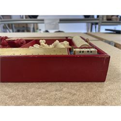 19th century walnut and brass bound games compendium box, painted to enhance the grain, of rectangular form, the hinged opening cover with rounded sides, central brass cartouche with engraved lion crest, and brass riveted straps, opening to reveal a red leather and blue silk lined compartmented interior, with fold-down games board, and lift-out tray containing playing cards, ebony turned dice towers, white and red stained bone draughts, and chess pieces, ivory dice, and ivory and ebony whist markers, and brass bezique board, cribbage board and markers, H15cm W32cm D24cm
This lot has been registered for sale under Section 10 of the APHA Ivory Act