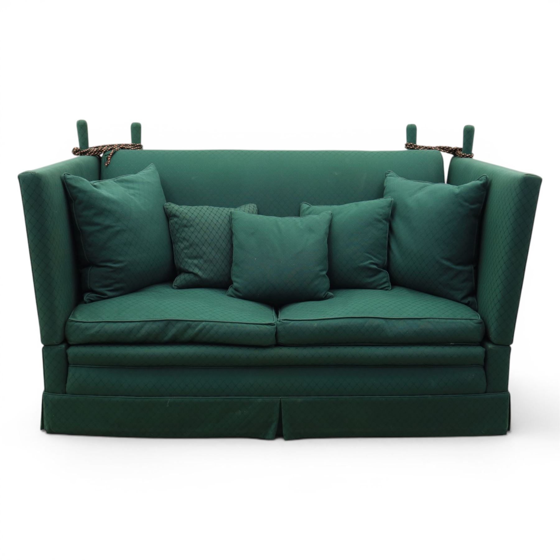 Late 20th century two-seat Knole sofa, covered in green woven fabric with lattice pattern, high panelled back and hinged drop arms secured by braided cords, loose cushioned seat and back with additional scatter cushions, on plinth base