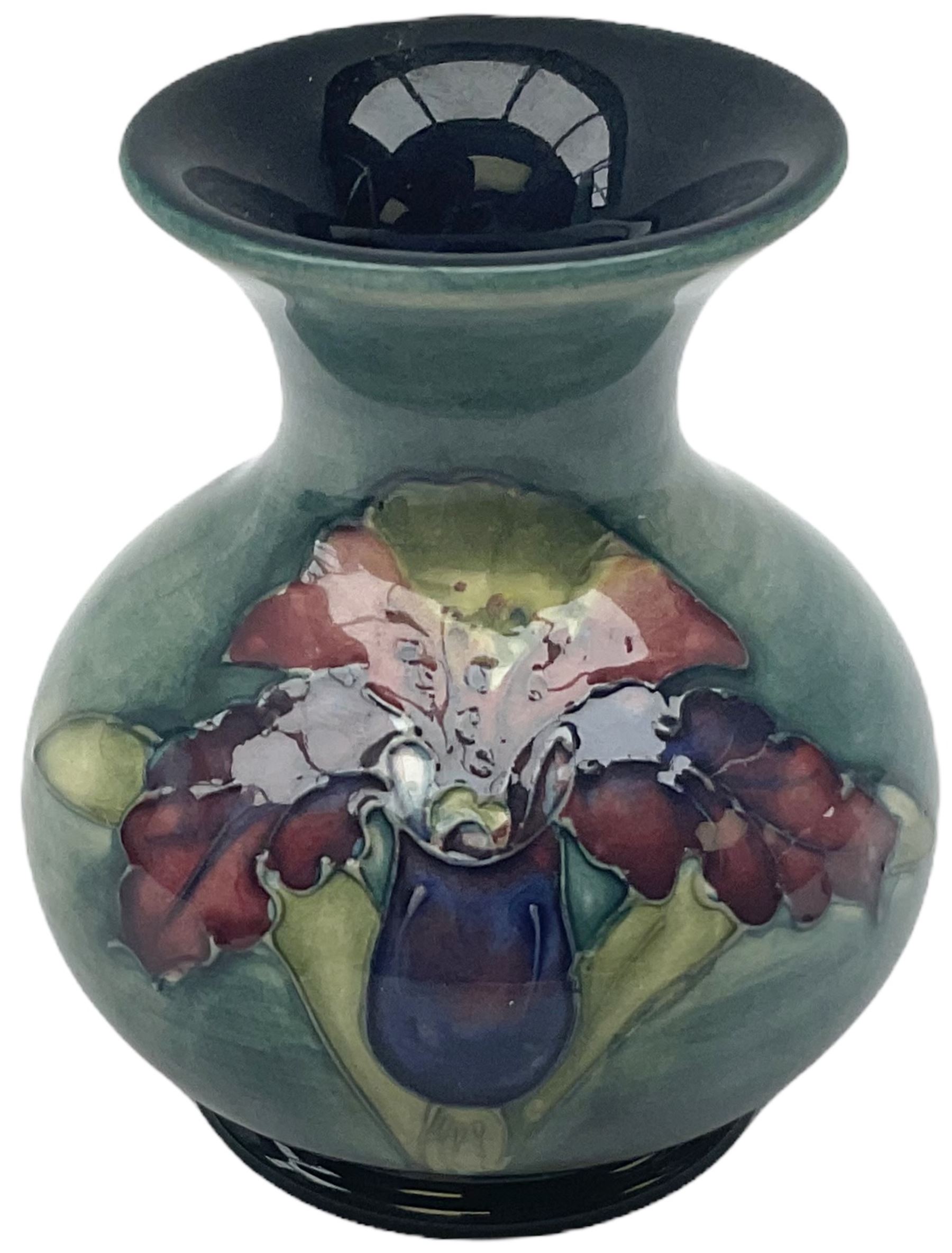 Moorcroft vase, decorated in the Leaf and Berries pattern upon a tonal green ground, together with a further Moorcroft vase, of squat baluster form, decorated in the Iris pattern upon a tonal green ground, each with impressed marks beneath, each H9cm. 