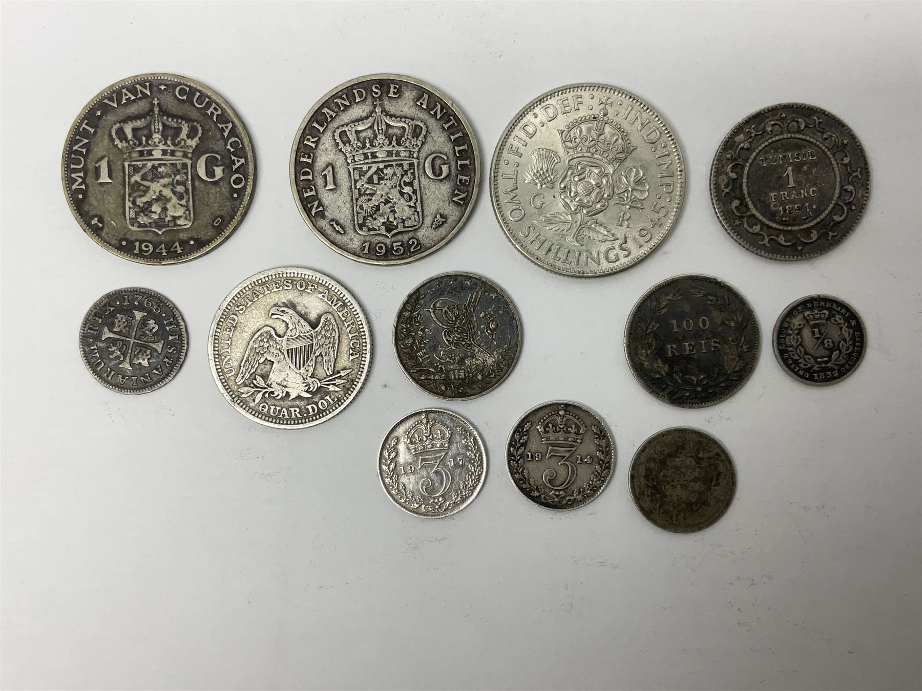 Twelve World coins, including William IIII United Colony of Demerary and Essequibo 1832 one eight guilder, United States of America 1857 quarter dollar, Tunisia 1891 one franc etc 