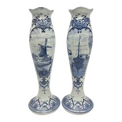 Pair of Delft blue and white vases, of elongated baluster form with shaped fluted rim, one depicting a Dutch sailing scene, the other a Dutch windmill scene, with painted mark beneath, H35.5cm