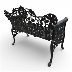 Coalbrookdale style - cast iron garden bench, with pierced foliate back, rams head arms, raised on cabriole legs, finished in green paint.