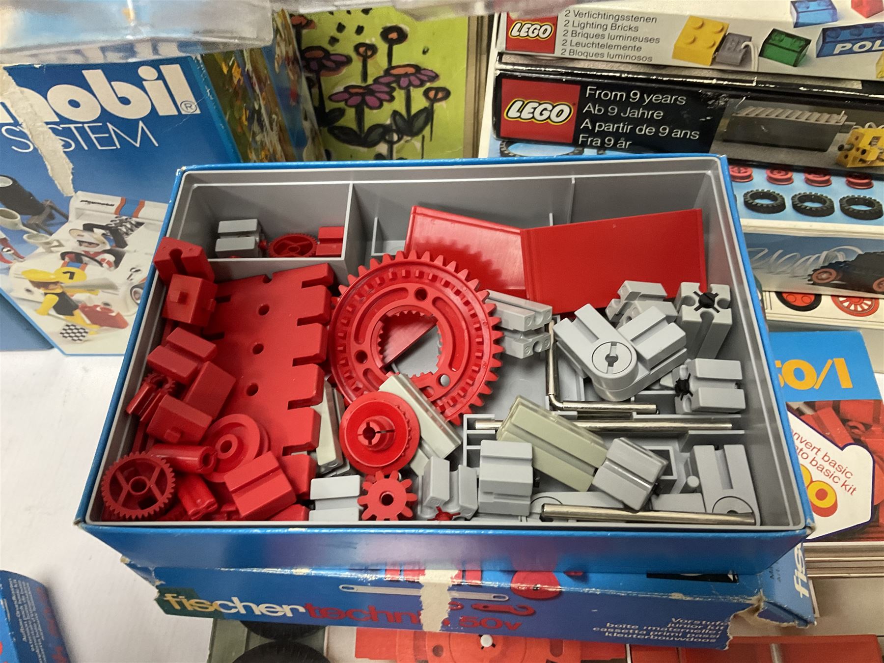 Fischer Technik/Lego/Playmobil - thirteen model building sets comprising eight Fischer Technik sets 50, 50/1, 50v, 50/2, 50+mot1 and two 50S, 50/1 add-on pack, with spare parts packs 01, 03, 05, two 22 and 30; two Lego sets comprising C107 and Lego Systems 103, part-set 870 and 970; Playmobil no.3520 set; four boxes of loose lego, various instruction manuals and a scrapbook 