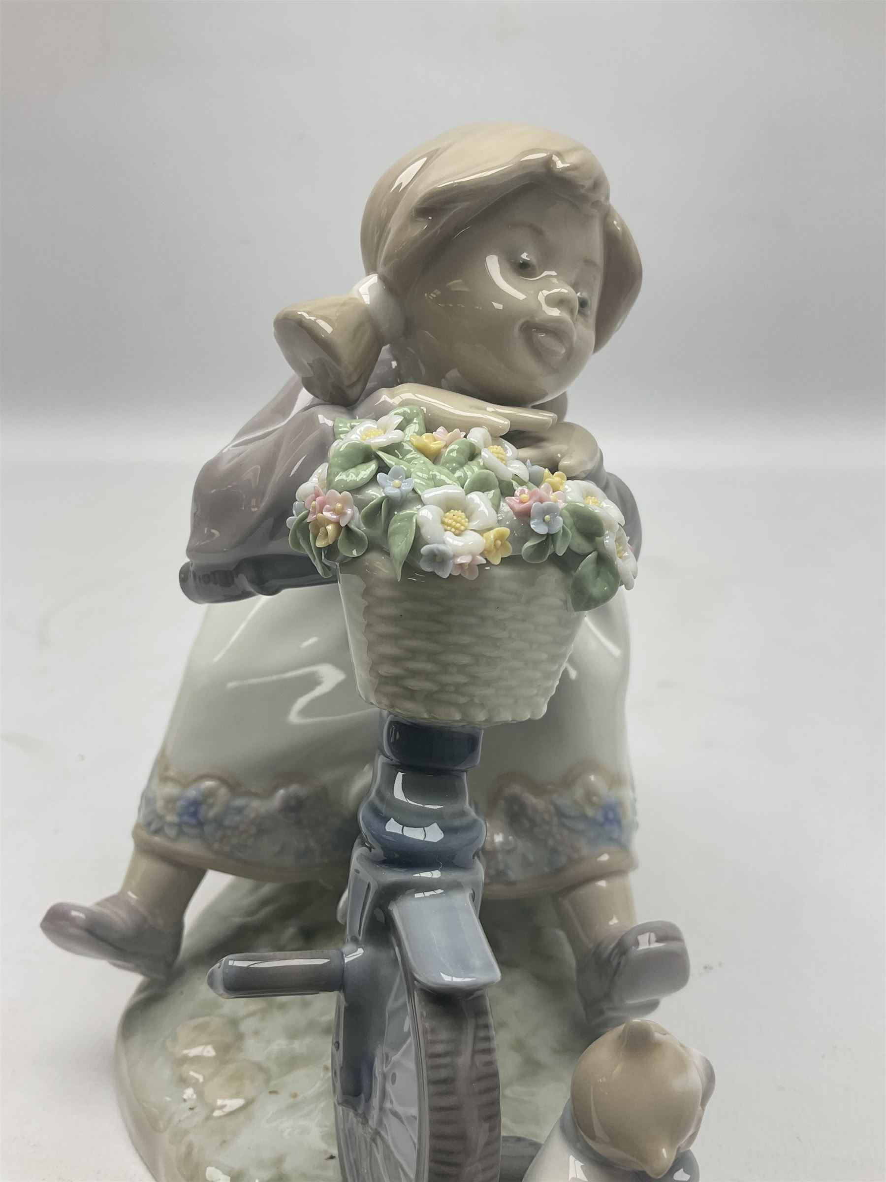 Lladro figure, In No Hurry, modelled as a girl on a tricycle, sculpted by Francisco Polope, with original box, no 5679, year issued 1990, year retired 1994, H15cm
