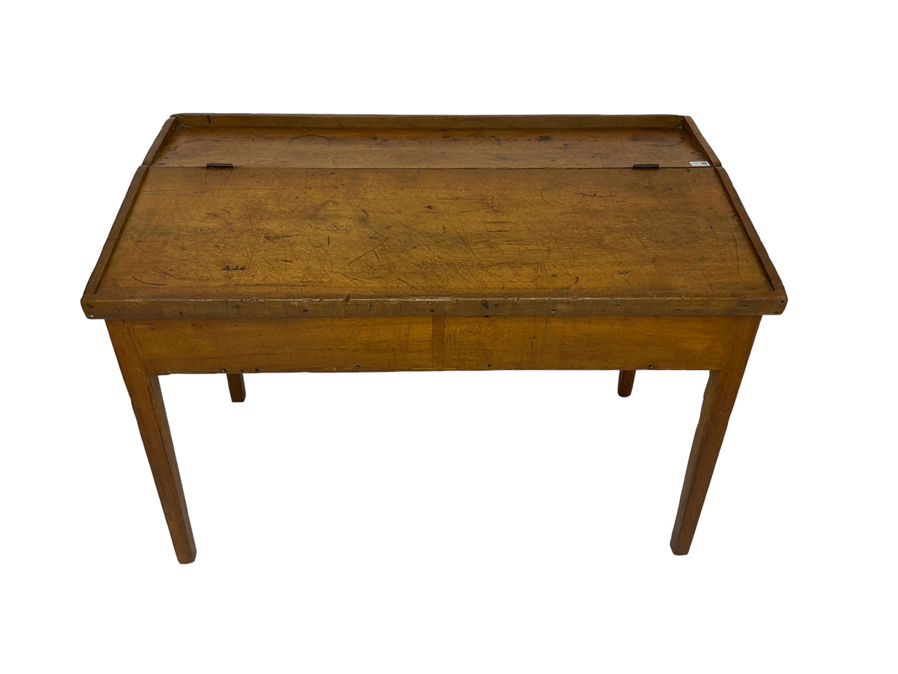 Late 19th century walnut school desk, sloped hinged lid, on square tapering supports 