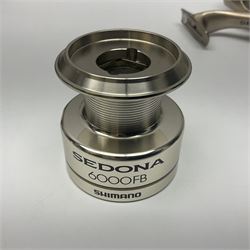 Four fixed spool reels, all in original boxes, comprising Shimano Ultegra 5500 XSD, with spare spool, Mitchell Autosurf 700, with spare spool, Shimano Sedona 600 FB with spare spool and D.A.M Quick 5001