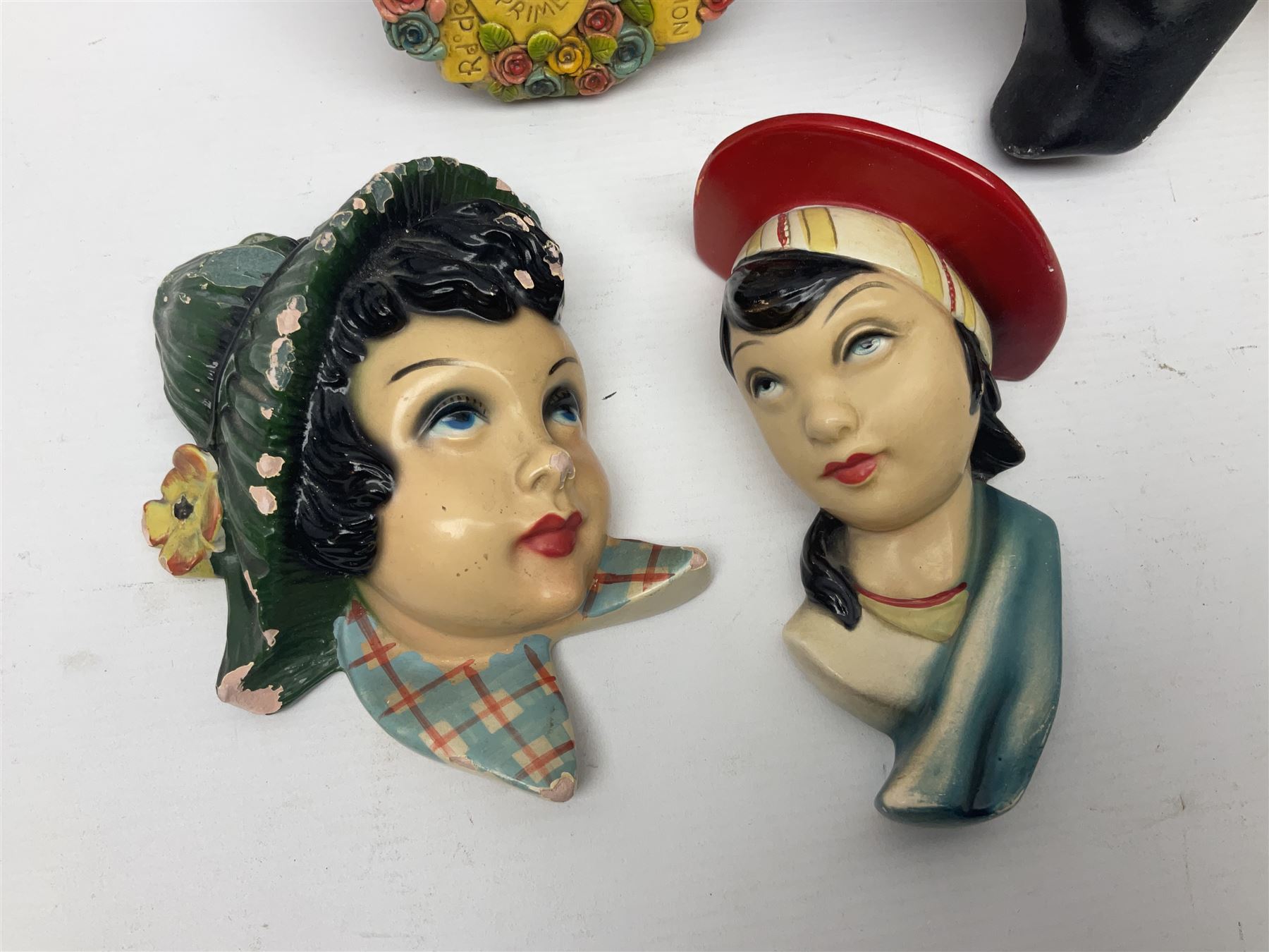 Art Deco plaster female bust, marked Arnova 353, together with a collection of wall masks 