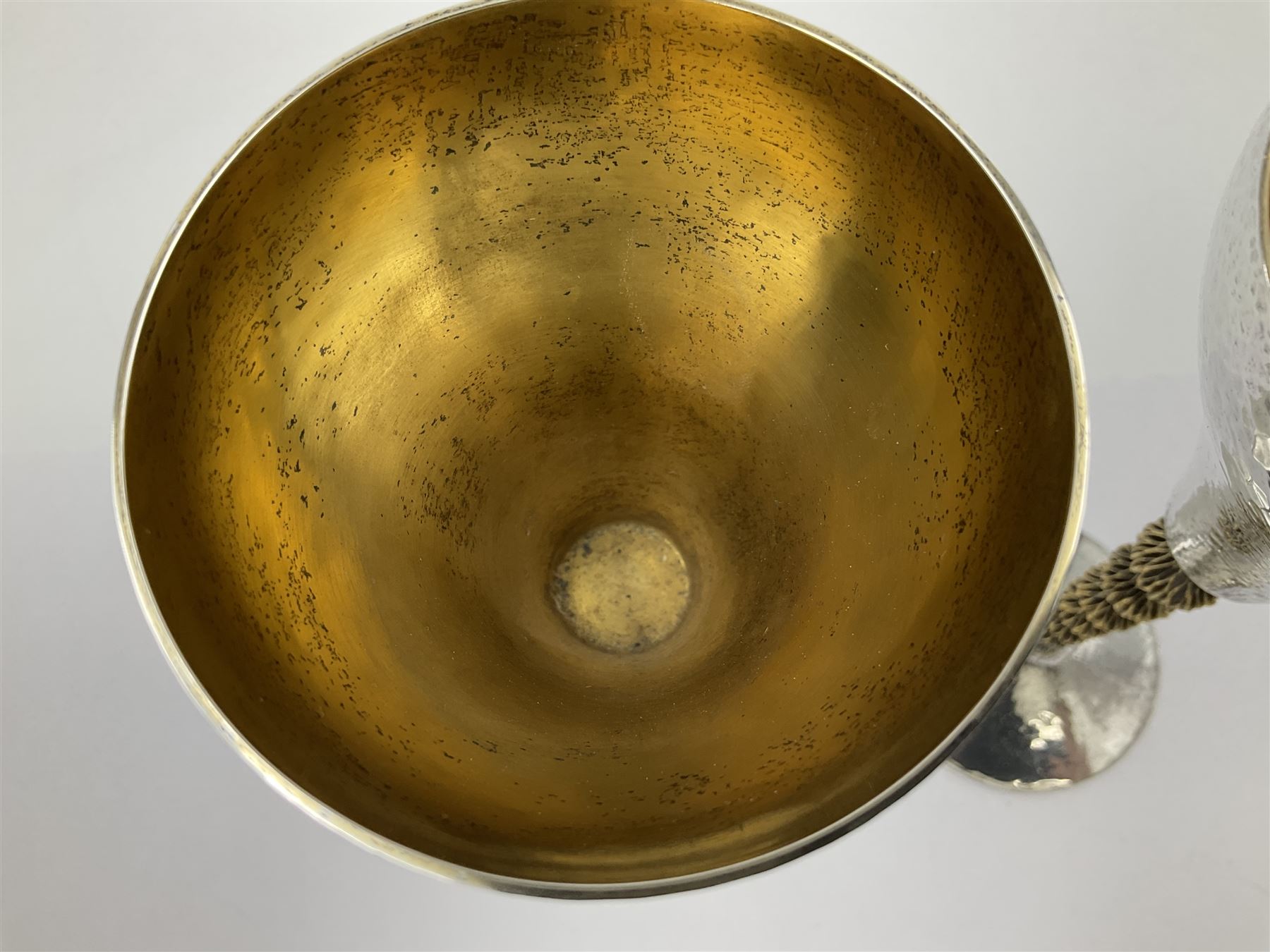 Pair of modern silver goblets by Stuart Devlin, the tapering cylindrical bowls each with spot hammered decoration and gilt interiors, the parcel gilt stems with signature textured detailing and six graduating knops, upon conforming spreading circular foot, hallmarked Stuart Devlin, London 1976, H17.7cm