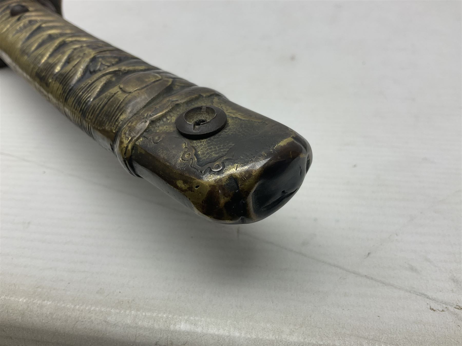 Copy of a WWII Japanese NCO sword, the 65cm slightly curving blade stamped with pseudo Japanese characters and cast brass simulated cord bound grip; in officer's leather bound field scabbard L97cm overall