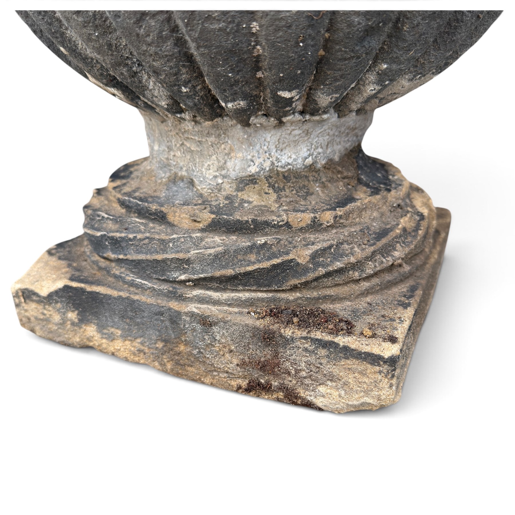 Set of three 19th century weathered carved sandstone garden urns of Neoclassical campana form, the broad everted rim carved with pointed egg-and-dart motifs, above a plain waisted bowl with gadrooned underbelly, on moulded rope-twist socle and square plinth base