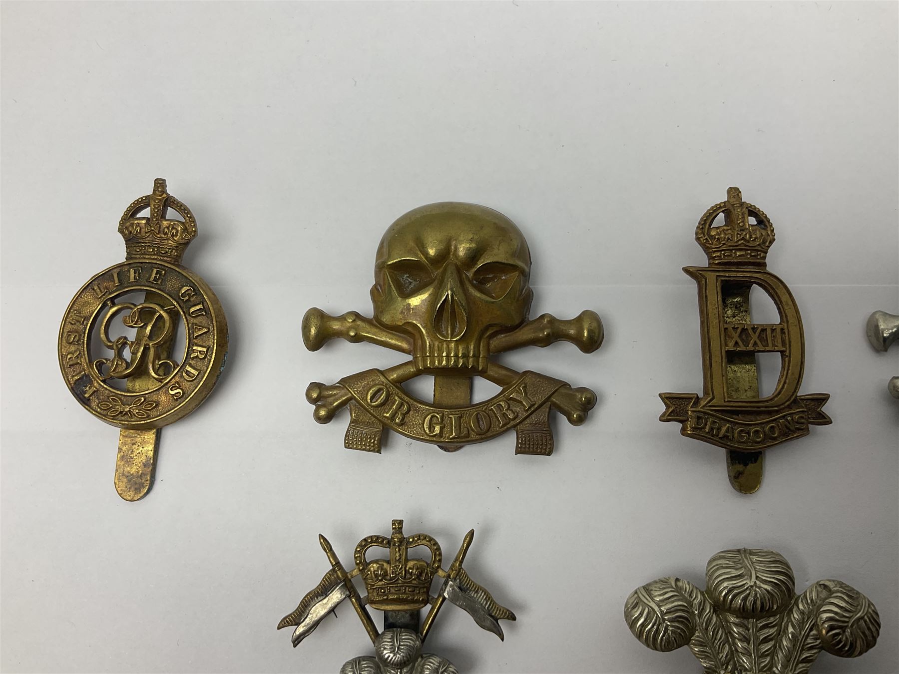 Nine Lancers metal cap badges including 9th, 12th Royals, 24th, 16th Queens and 17th; together with eight various Guards/Dragoons badges (17)