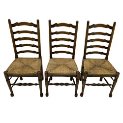 Set of six 18th century style oak dining chairs with waved ladder backs and drop in rush seats