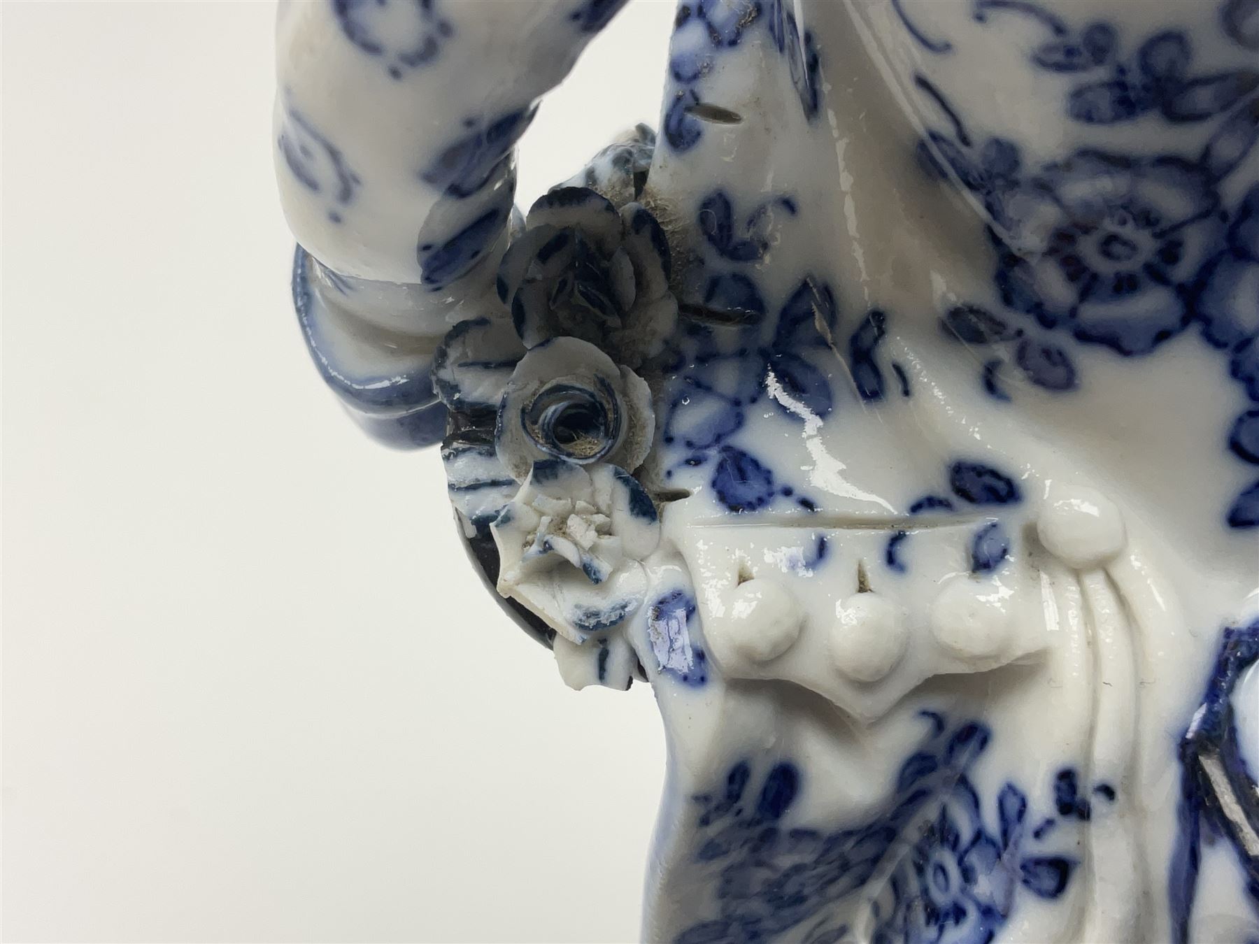 Meissen blue and white figure, modelled as a gentleman holding a hat of flowers, raised upon Greek key design base, with blue crossed swords and impressed C 73 and 149 marks beneath, H18cm