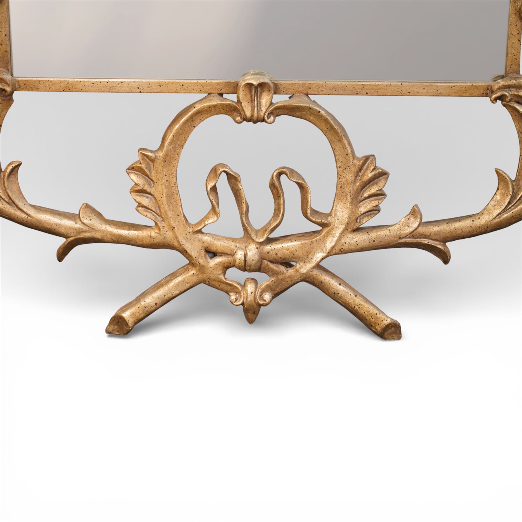 Large metal framed wall mirror, of rectangular form within an ornate openwork frame cast with scrolling foliate decoration and pierced cresting, finished in a gilt tone