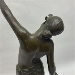 Bronzed semi nude female figure with one hand raised, upon a marble plinth, H43cm  