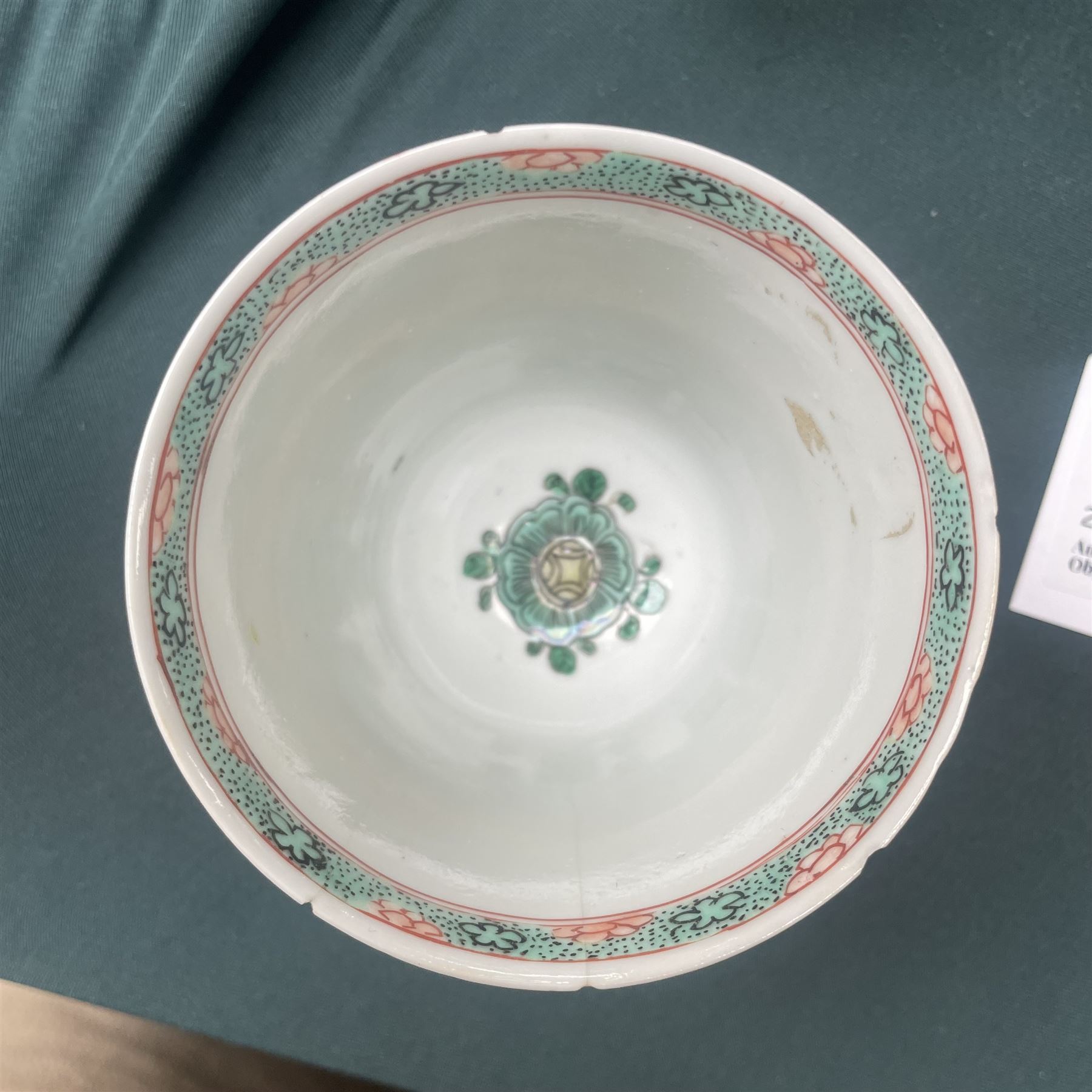 Three Chinese famille verte examples, approximately Yongzheng period, to include two teabowls and two saucers, each decorated with flowers and butterflies, two with sacred fungus mark within double rings, the teabowl with lotus mark, the other indistinct - possibly a Wan mark within lozenge (4)