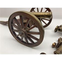 Large model brass cannon, upon wooden base, together with two similar smaller cannons, largest L48cm
