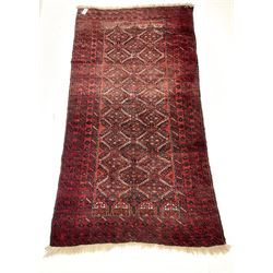 Persian red ground rug with repeating lozenge design 