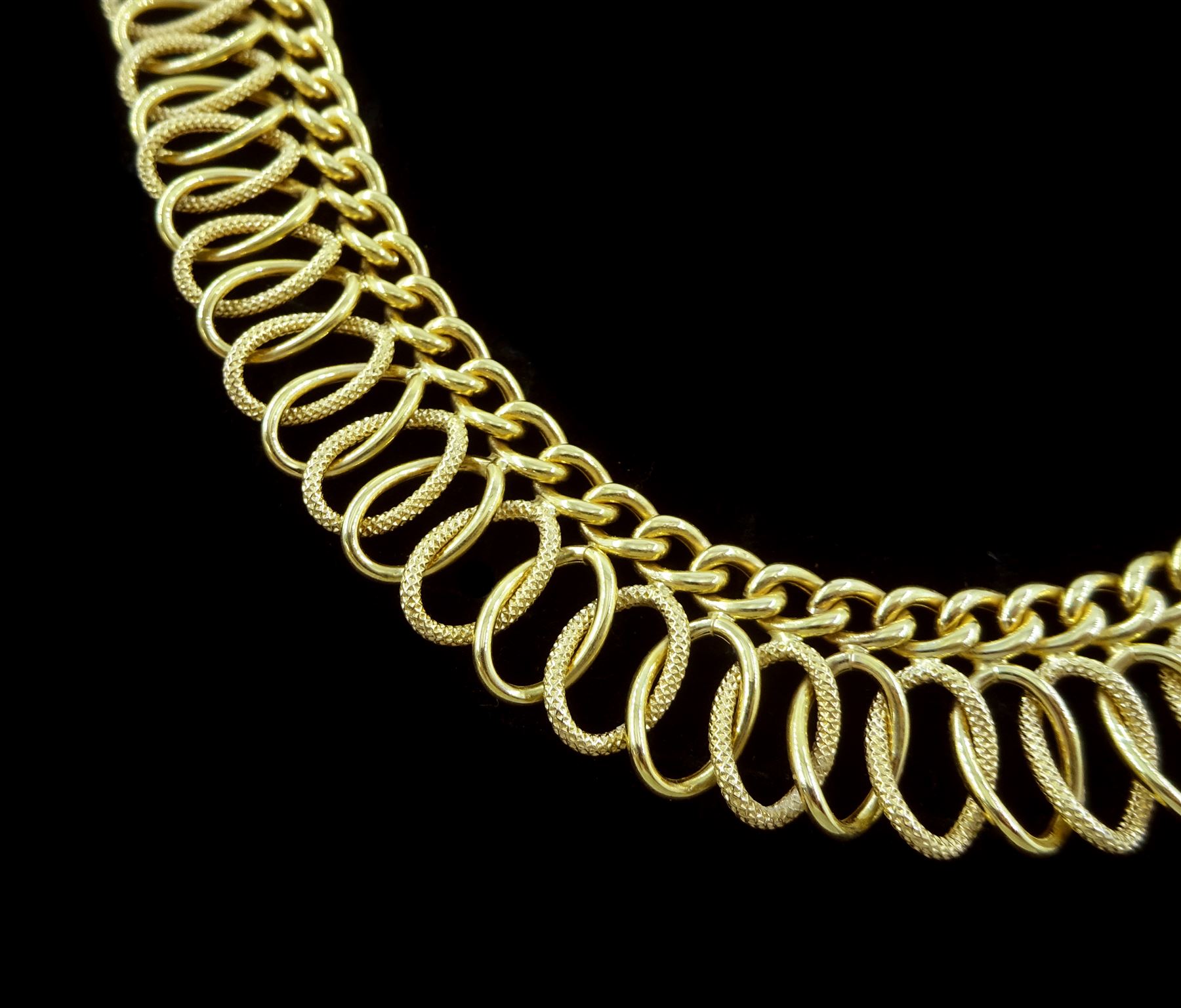 18ct gold fancy link necklace, polished and textured curb and woven openwork links, stamped 750