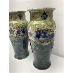 Pair of Doulton Lambeth stoneware vases, of baluster form, with floral and foliate decoration upon a mottled blue/green ground, impressed mark and hd 8315 beneath, H34cm