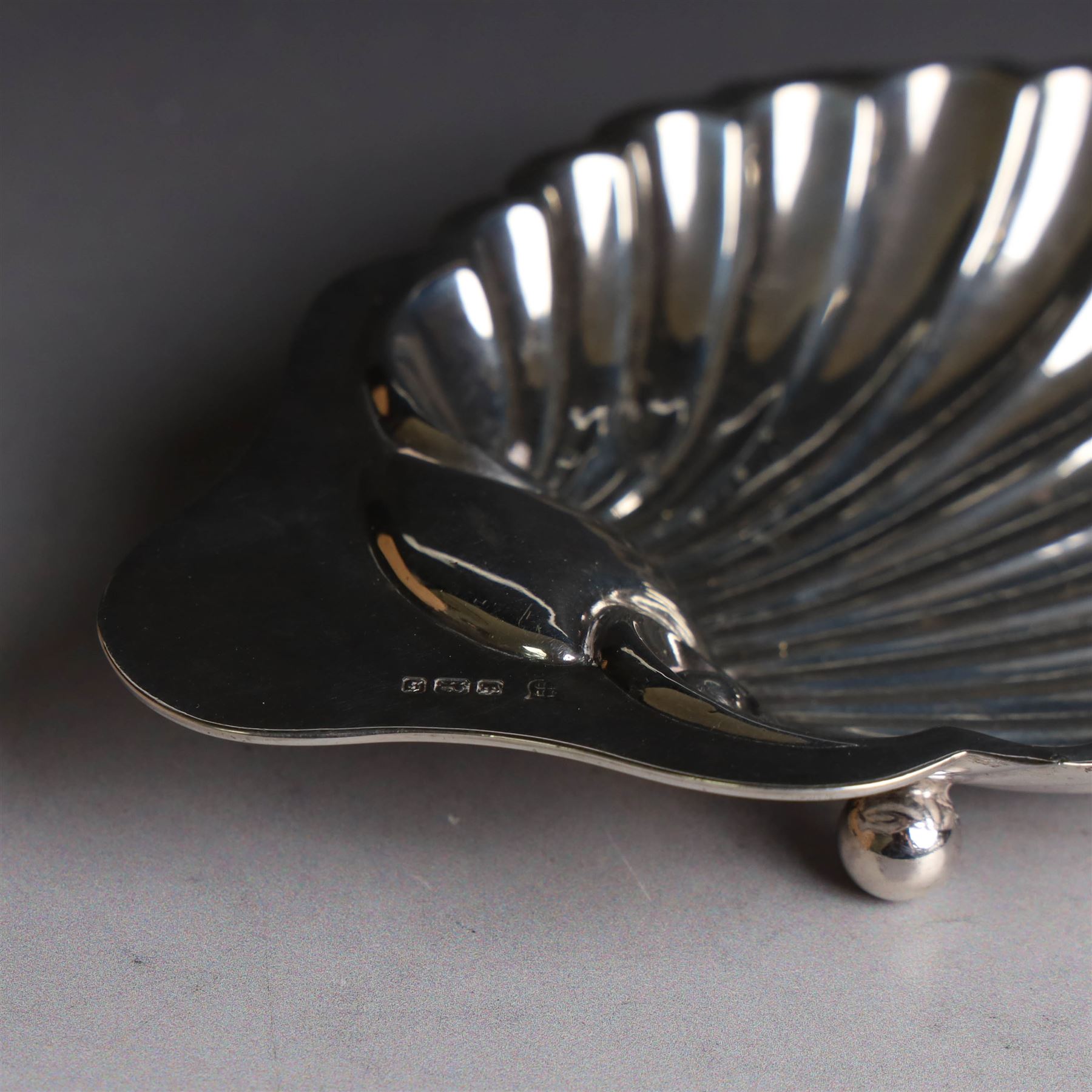 Edwardian silver clam shell butter dish, upon three bun feet, hallmarked James Deakin & Sons, Sheffield 1910