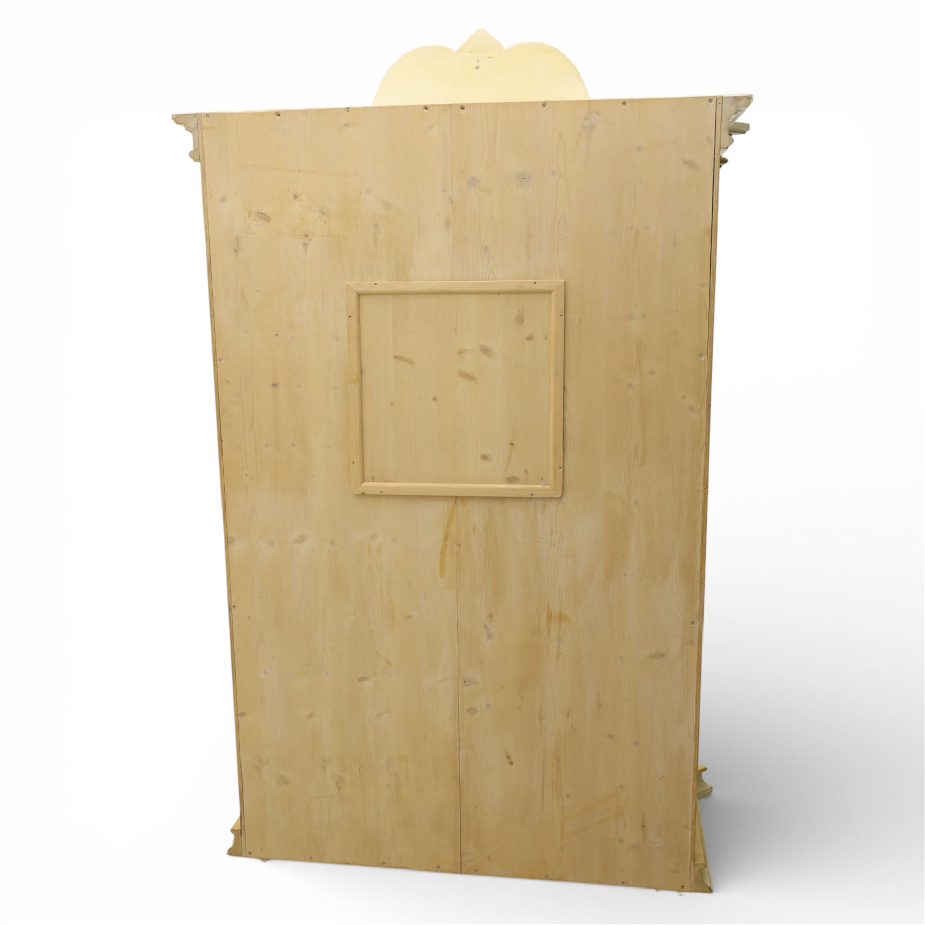 20th century French white and parcel gilt painted armoire, the shaped and scroll moulded cornice centred with a stylised foliate, the double doors with raised panel reserves applied with gilt foliate scrollwork, flanked by fluted pilasters with floral capitals, opening to a fitted interior with shelving and hanging space, raised on a moulded plinth on squat bun feet