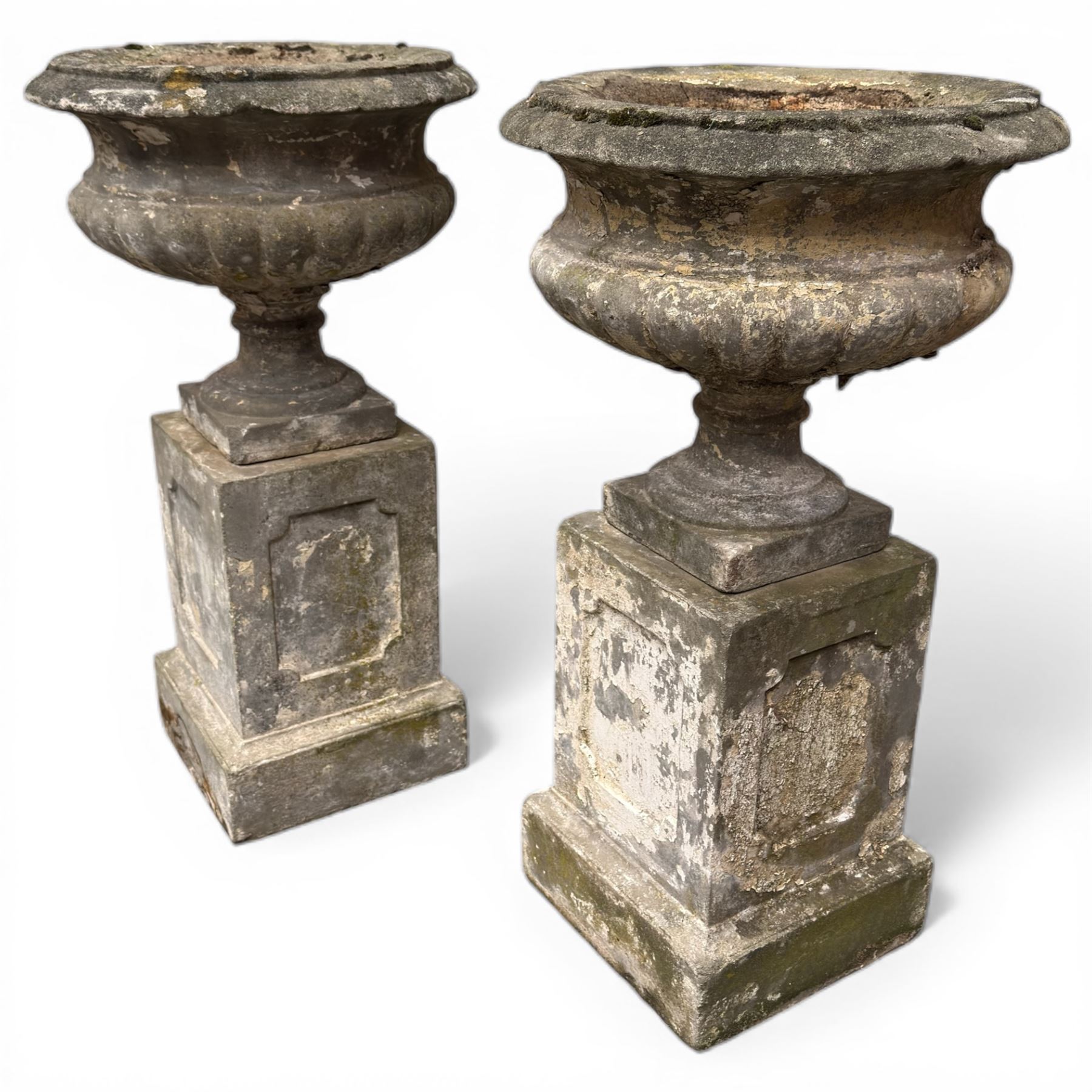 Pair of 20th century cast stone urns on plinths 