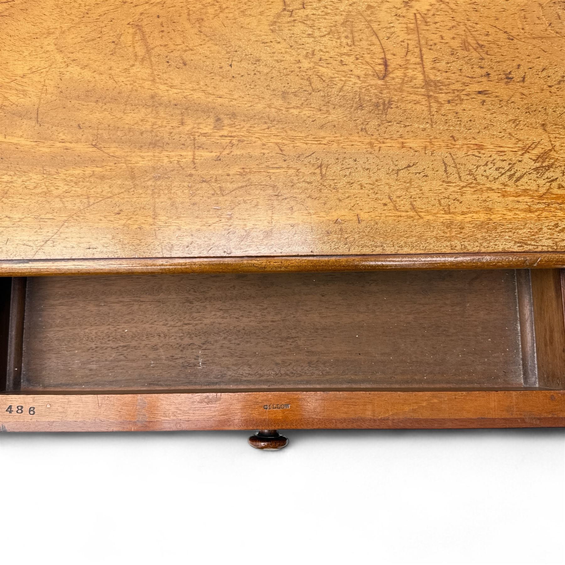 Late Victorian mahogany side table in the style of Gillows of Lancaster, mahogany rectangular top above two frieze drawers, the top edge of the right drawer stamped 'Gillow' and 'L486' with knob handles supported on turned stop and fluted legs with stretcher base on recessed castors

Provenance: The Davies-Cooke Collection from Gwysaney Hall, North Wales  