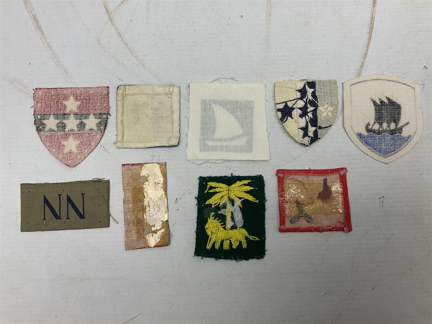 Approximately one-hundred printed and embroidered cloth badges including Royal Tank Regiment, Royal Armoured Corps, 219th Independent Infantry Brigade, Cyrenaica, Cyprus, Singapore and other districts, Gibraltar Garrison, East Anglian Brigade, 20th Armoured Brigade and various armoured divisions etc