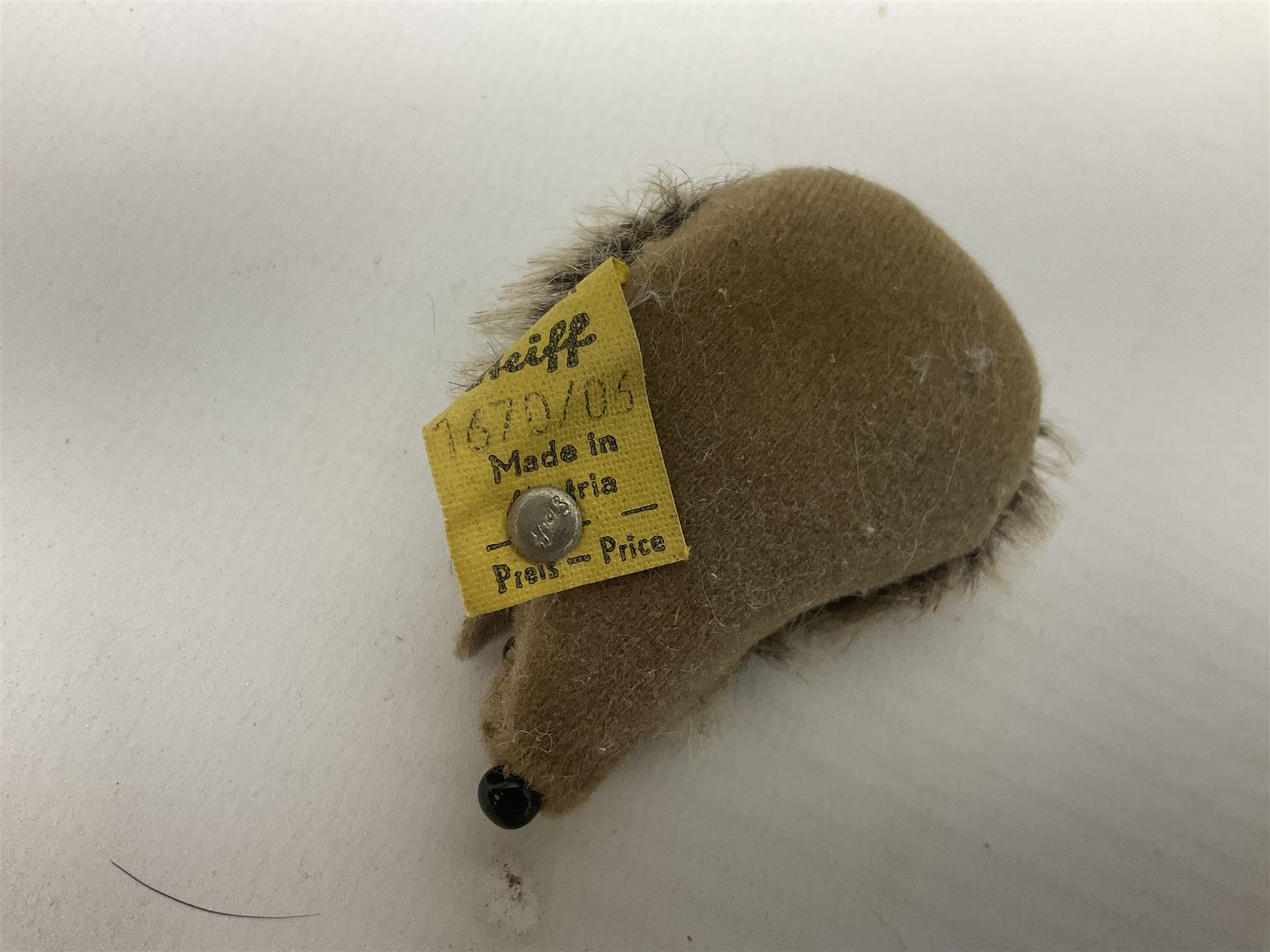 Group of Steiff figures, comprising Mikki and Mukki, circa 1950s no 7628/12 and 7627/12, with original tags, two hedgehogs no 1570/10, and another smaller 1670/03, small owl no 7480/06, and painted metal Steiff harlequin style bear