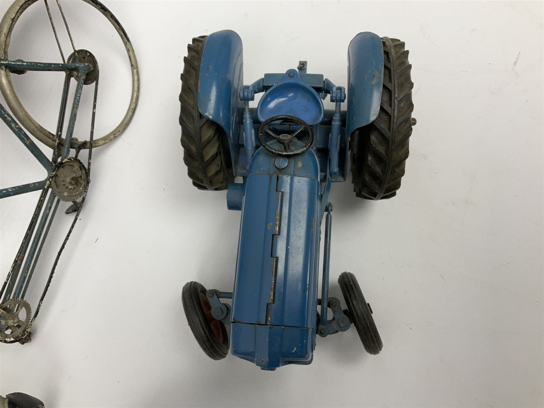 Chad Valley clockwork Fordson Major Tractor, a group of play worn Britains and other lead and metal farm animals, figures and accessories including a kennel, haystacks, dovecote, cows, sheep etc, together with a diecast model of a Tandem Bike L31cm