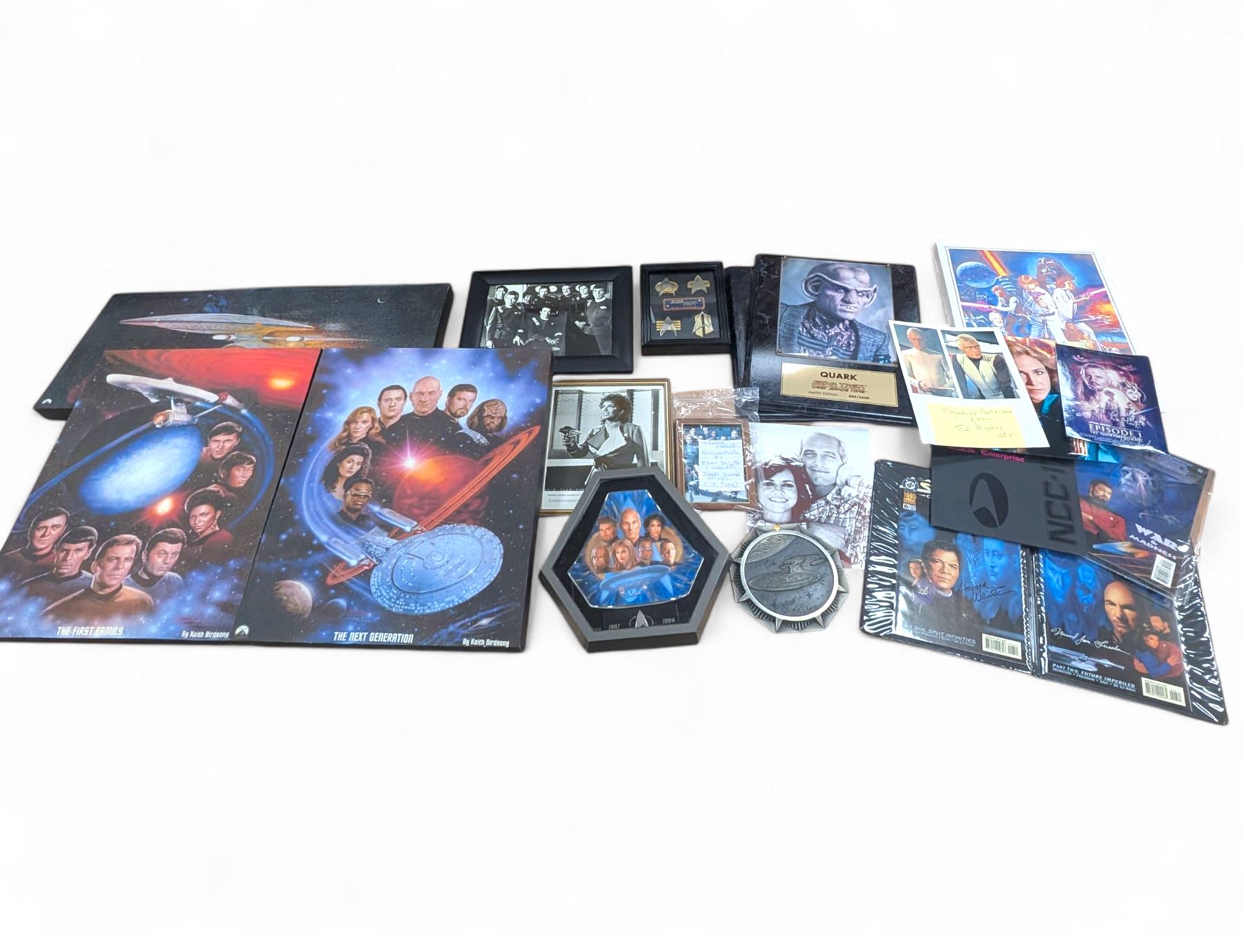Collection of Star Trek The Next Generation and Deep Space Nine memorabilia, including two limited edition signed Star Trek Deep Space Nine photographs, commemorative porcelain plaque, insignias, Encounter at Farpoint pewter plaque, signed photograph of the Voyager crew, two signed copies of Convergence and a signed War & Madness graphic novel, canvas prints and other signed photos, together with Star Wars Ray Park (Darth Maul) signed photograph, UFO and Buck Rogers memorabilia
