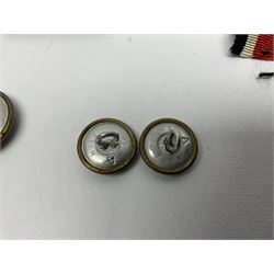 Collection of eleven German metal and cloth badges and uniform buttons including driver's badge, two 'SS' fabric skulls, private's shoulder tabs, Police cloth badge, tank destruction badge, medal bars and ribbon etc; most WW2 period