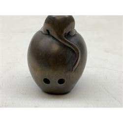 Netsuke in the form of a rat sitting on a skull, signed to the base