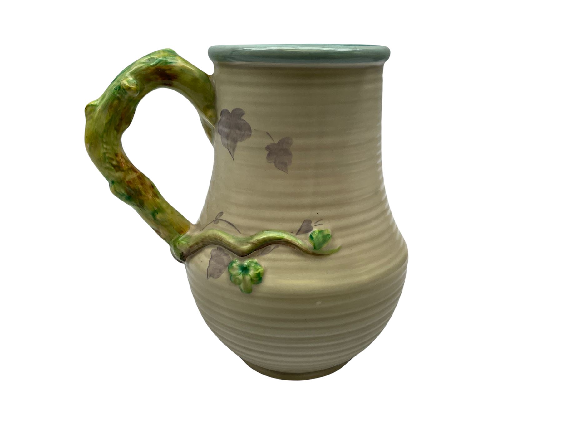 Clarice Cliff baluster jug moulded with a blue budgerigar perched upon branch with green rustic handle and mushroom glaze,  factory stamped beneath, H22.5cm