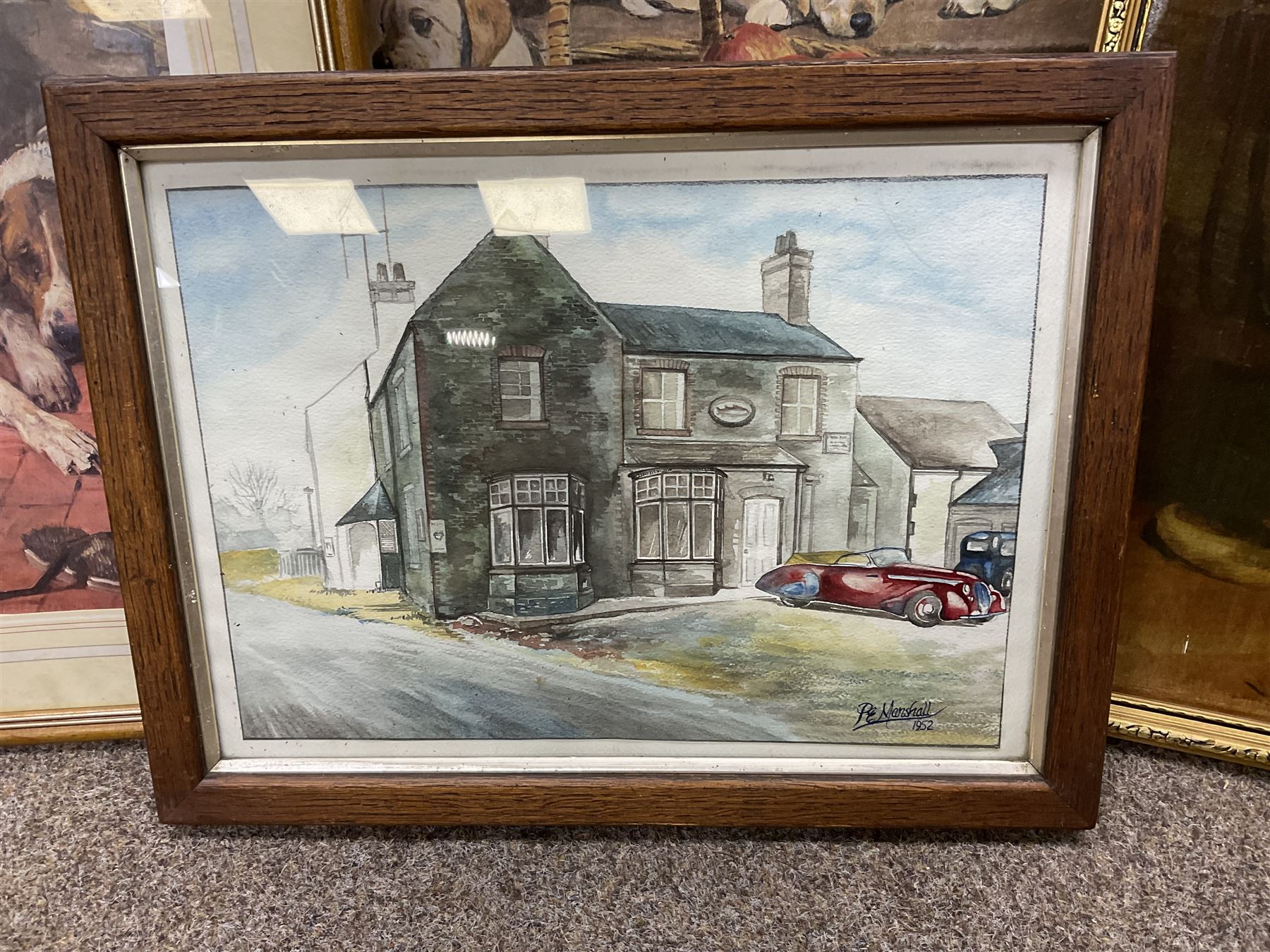 After P E Marshal (British 20th century), Car Outside Inn, water colour signed and dated; after Richard Britton (British) 'Mischief Makers' (golden labradors), colour print, together with three colour prints of dogs and embossed decorative bear scene (6) 