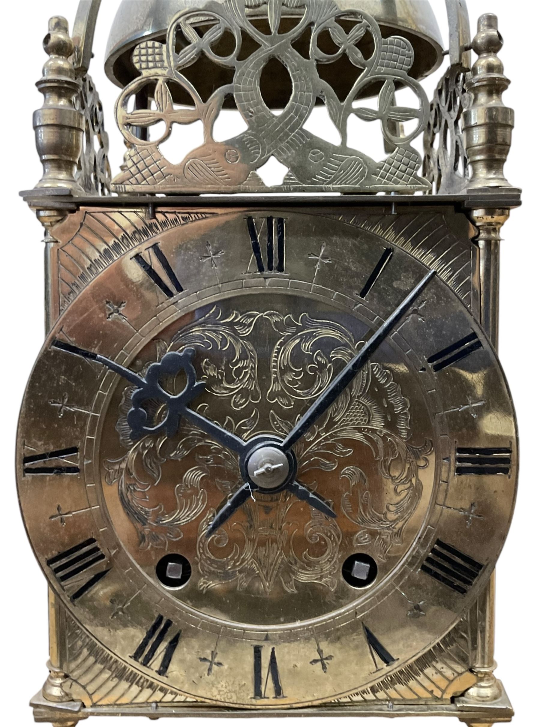 English - 20th century 8-day lantern clock in period 18th century style, square brass case surmounted by a domed bell, with a brass chapter, engraved dial centre and stylised period steel hands, with a two train spring driven movement striking the hours and half hours on a bell. With pendulum. 