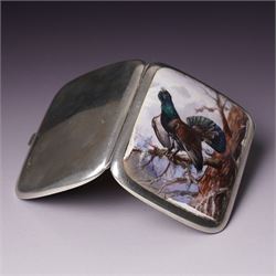 Early 20th century Continental silver and enamel cigarette case of rectangular cushion form, the front enamelled with a capercaillie in a Scottish woodland scene, marked 935, 9cm in length