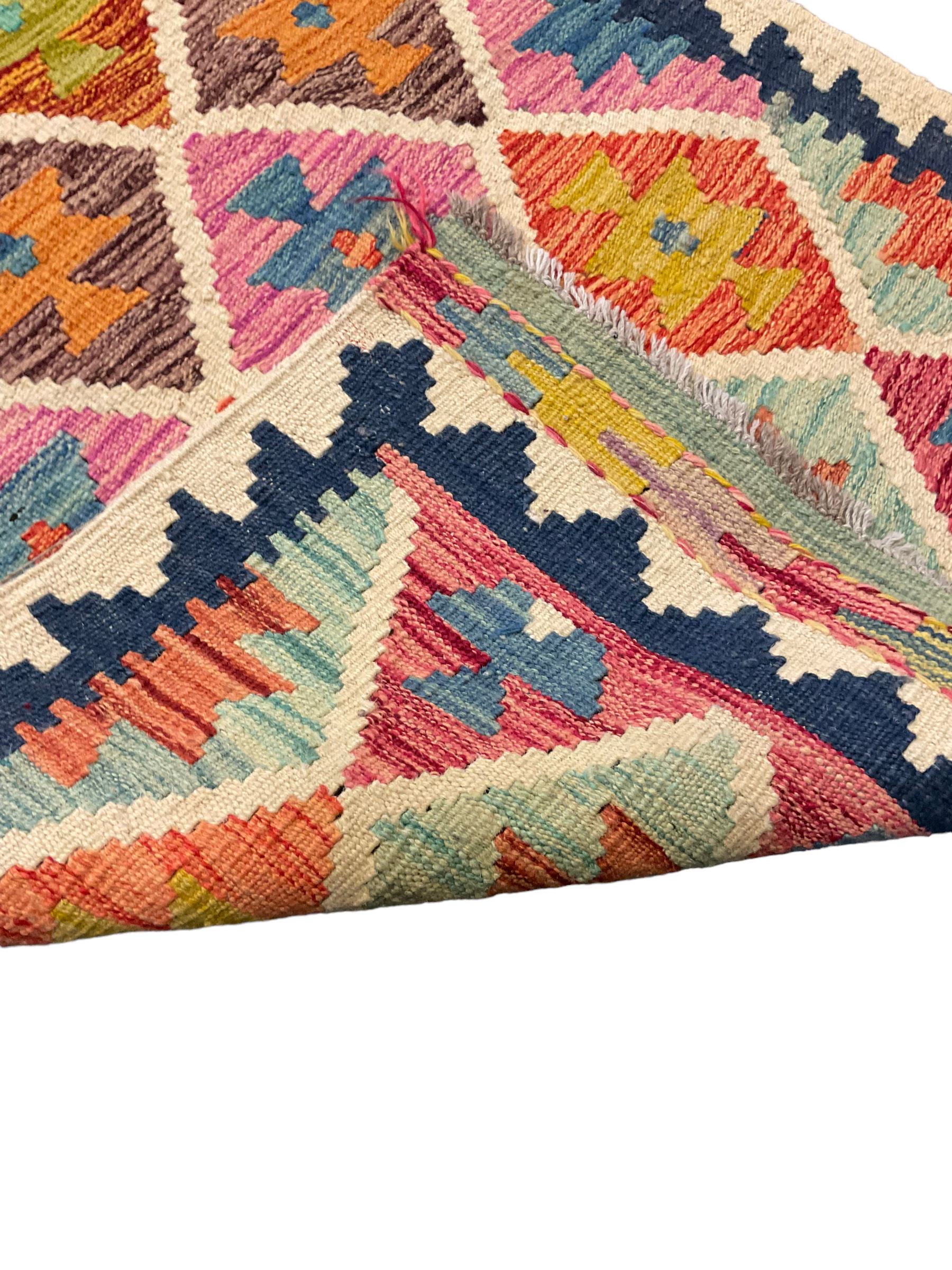 Anatolian Turkish Kilim ivory ground runner rug, decorated with all over multi-colour geometric lozenges with ivory outline